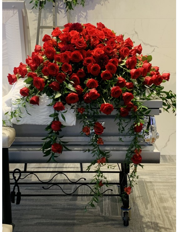 RED ROSE CASKET WITH CASCADING GREENS